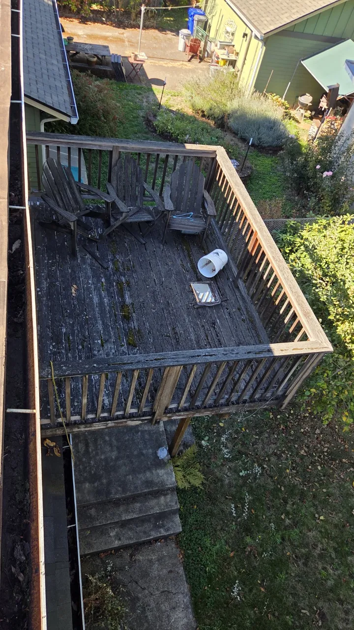 Before: old wood deck replaced with composite decking and black metal railings