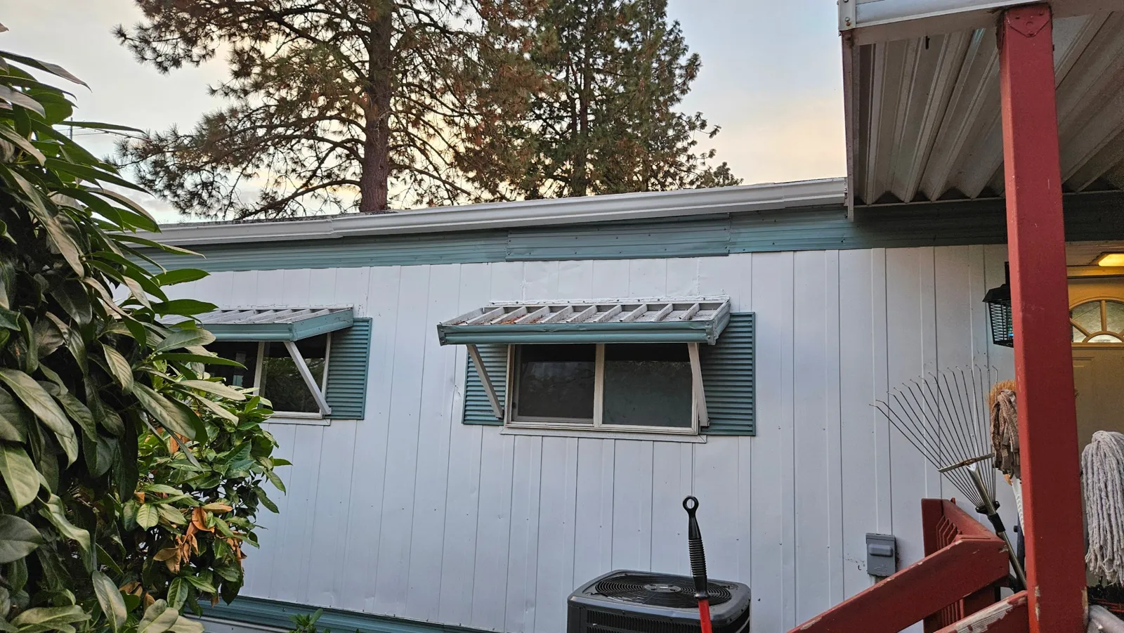 After: wall and roof edge rebuilt with new trim and gutter