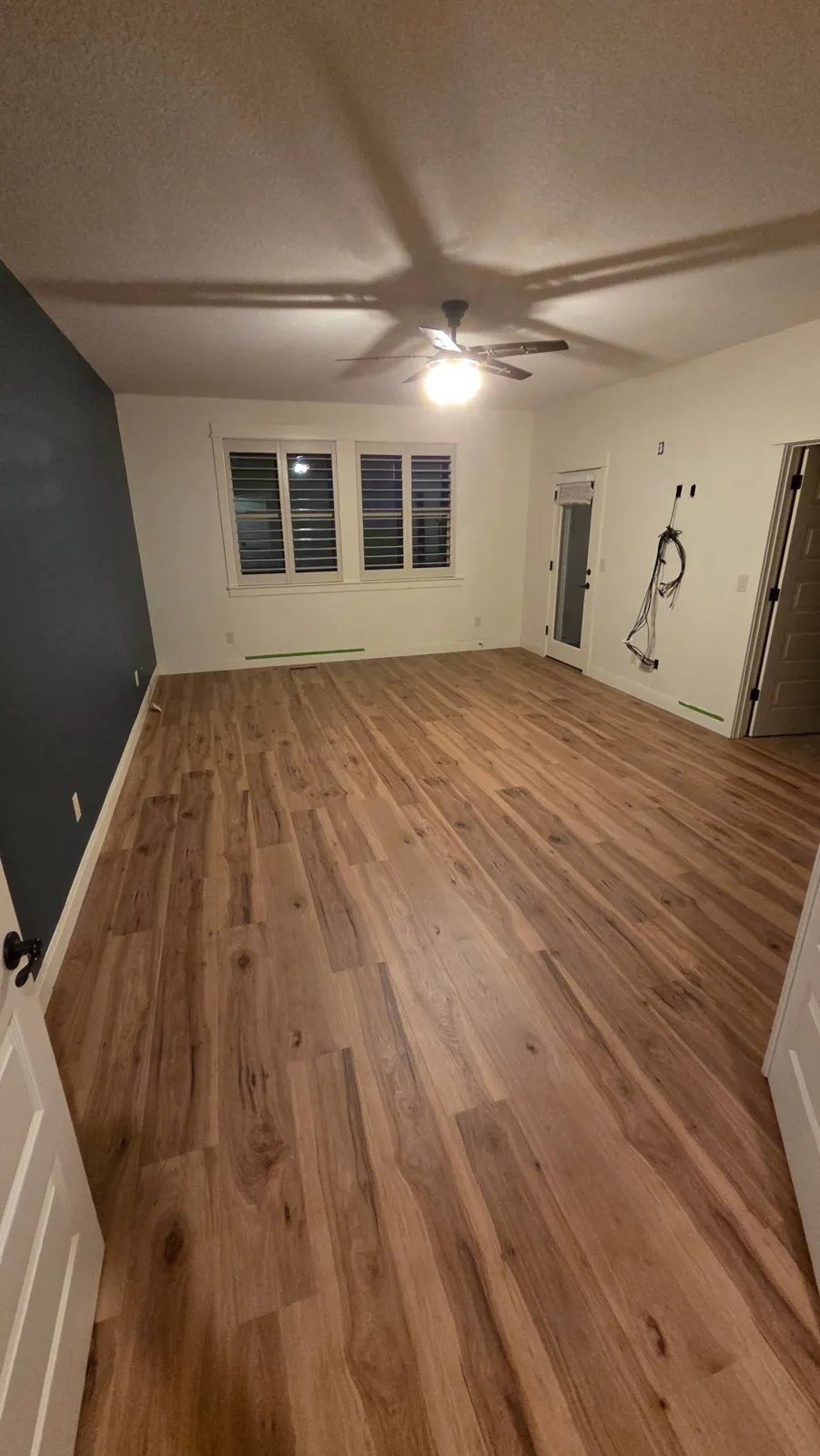 New wood-look plank flooring in a large bedroom