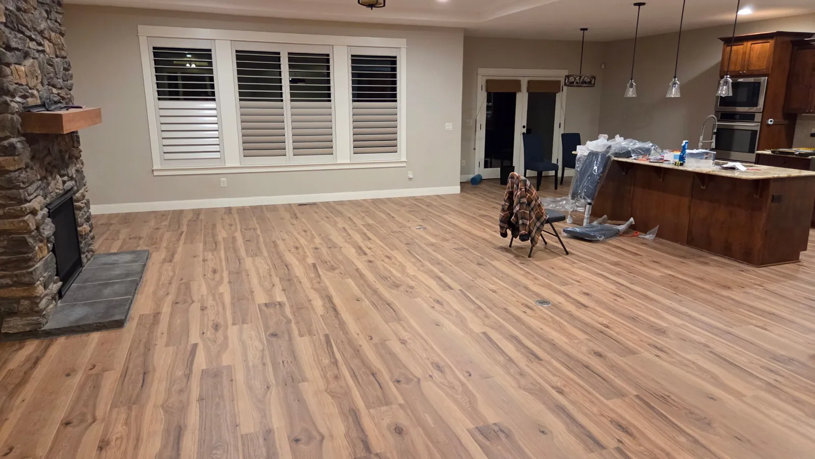New wood-look plank flooring in an open living room and kitchen