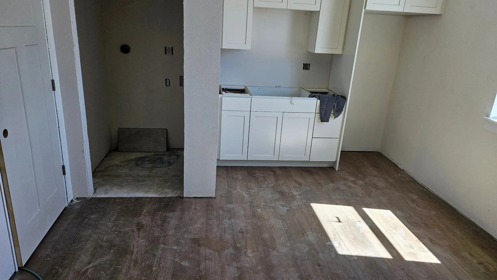 New vinyl plank floor and white shaker cabinets in a new unit